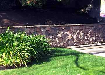 Properly engineered and drained retaining wall built to hold for decades